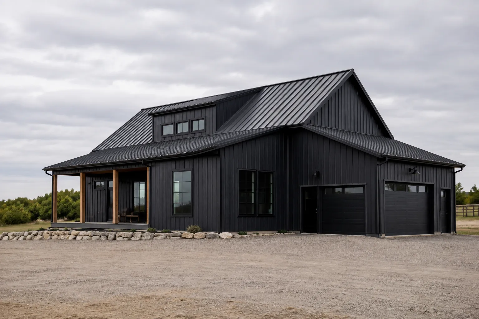Barn-style home with black standing-seam metal roofing and dark vertical siding