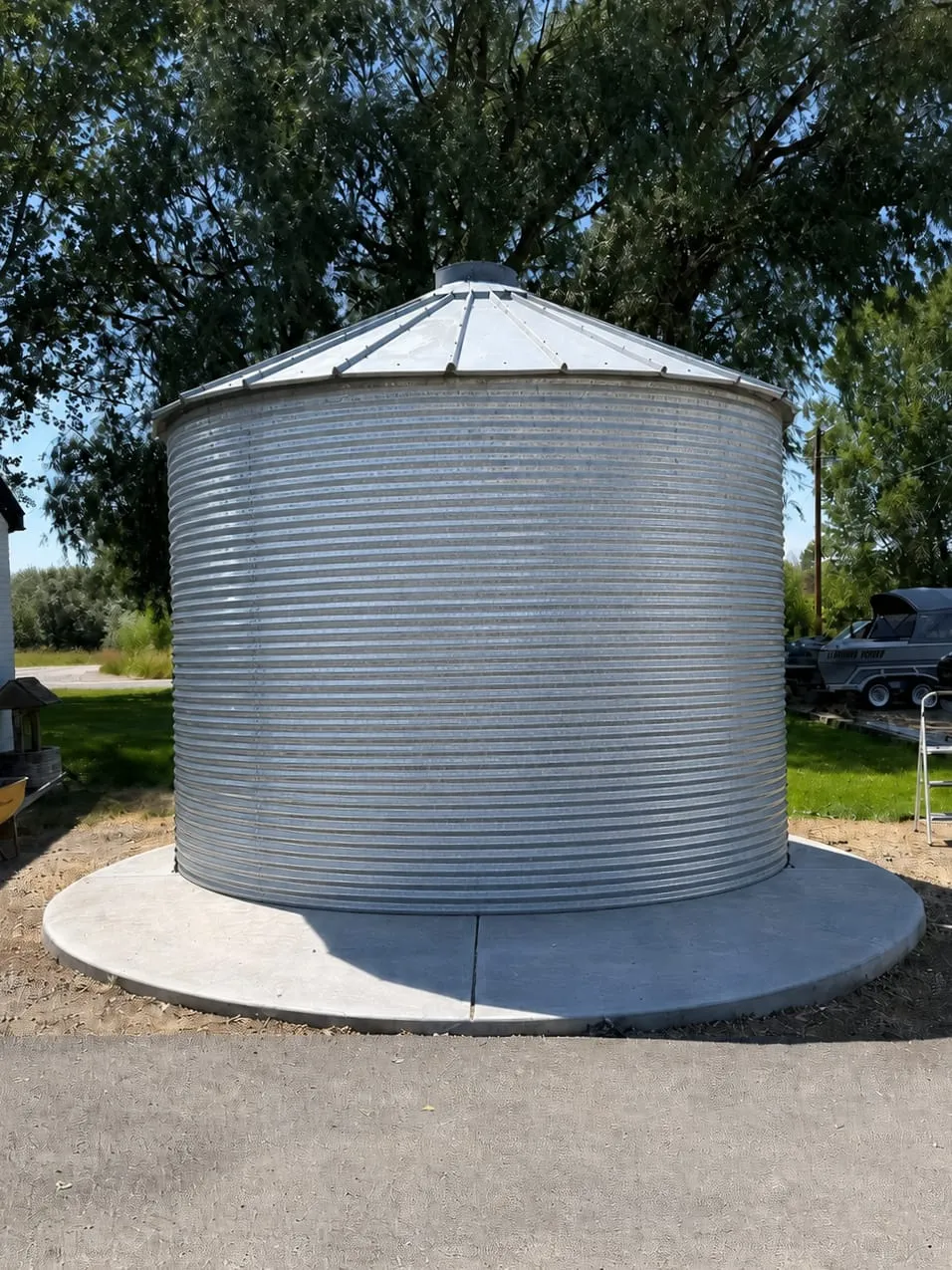 The original galvanized grain bin, closed and unconverted, on a new concrete pad
