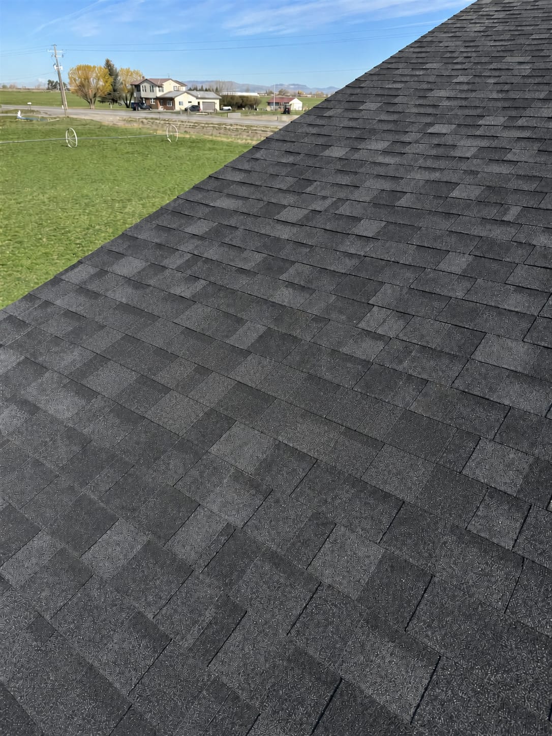 The same roof slope after repair, with new shingles blended into the existing courses